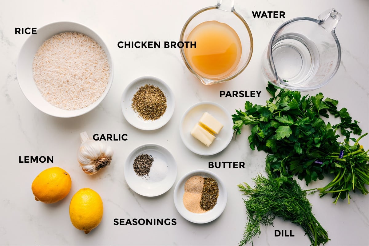 Ingredients In Greek Rice Recipe All the ingredients in this recipe prepped out for easy assembly including the rice, lemons, garlic, seasonings, butter, parsley, dill, chicken broth, and water.