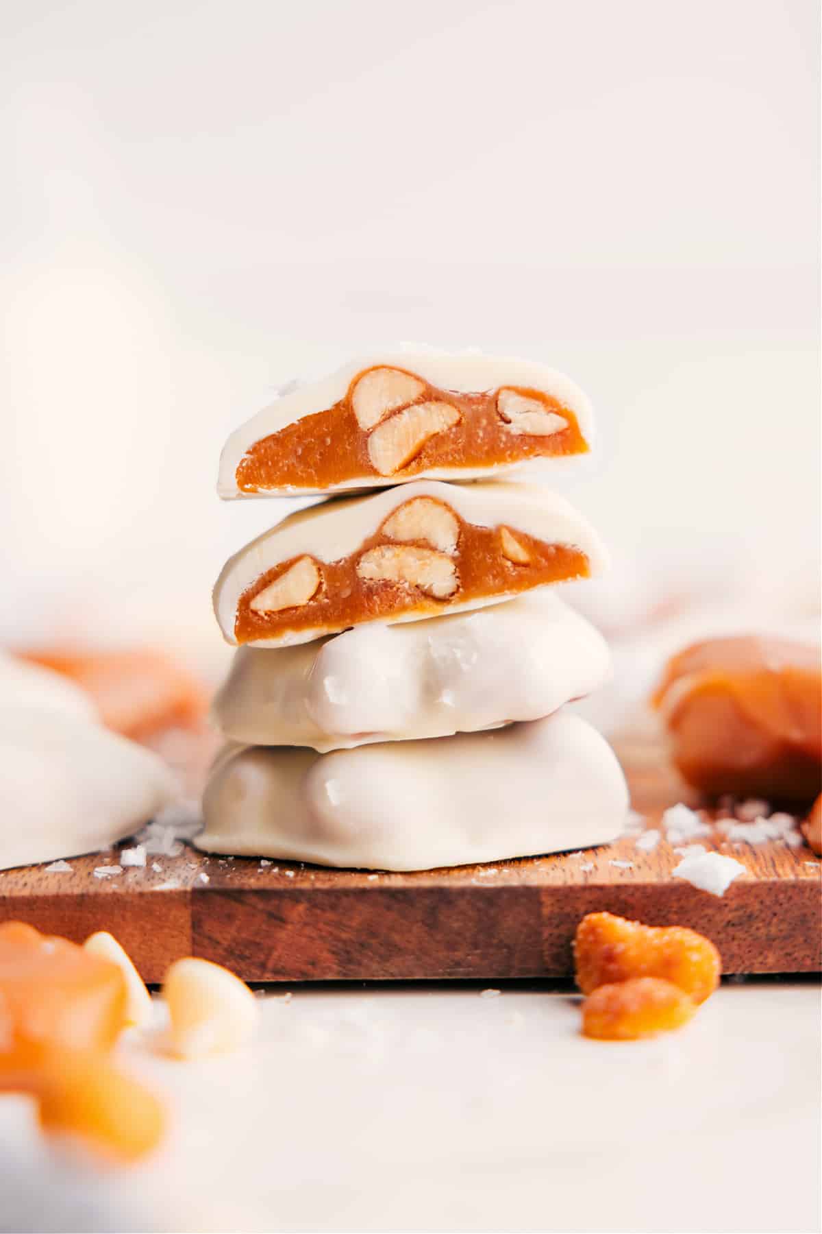 Polar Bear Paws stacked with the top pieces cut in half to show the caramel peanut center.