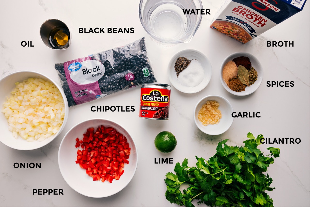 Ingredients In This Homemade Black Beans Recipe All the ingredients in this recipe prepped out for easy assembly including the oil, black beans, onion, pepper, chipotles, lime, water, spices, cilantro, garlic, and broth.
