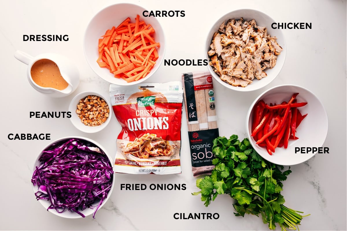 Ingredients In Soba Noodle Salad Recipe All the ingredients in this recipe prepped out for easy assembly including the dressing, peanuts, cabbage, fried onions, carrots, noodles, chicken, pepper, and cilantro.