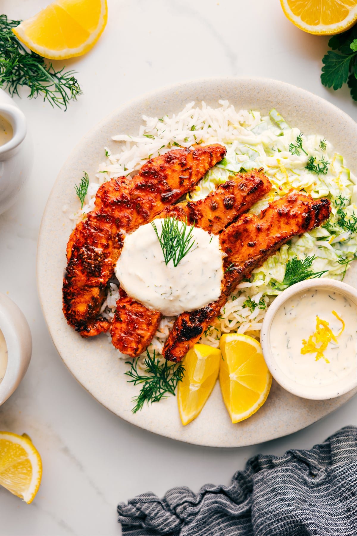 Fresh And Flavorful Blackened Salmon Recipe Blackened Salmon Recipe on a bed of rice topped with a lemon-dill sauce.