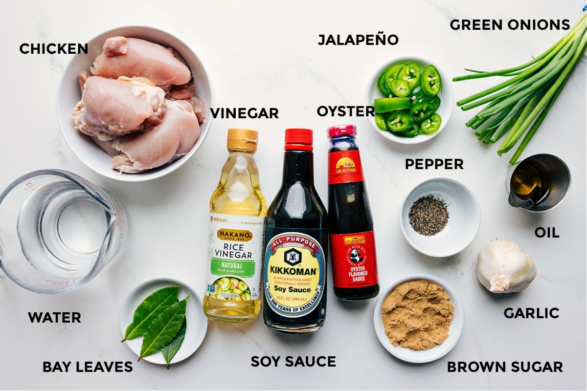 Ingredients In Chicken Adobo Recipe All ingredients for the recipe prepped and ready, including chicken, water, bay leaves, vinegar, soy sauce, oyster sauce, jalapeño, pepper, brown sugar, garlic, green onions, and oil.