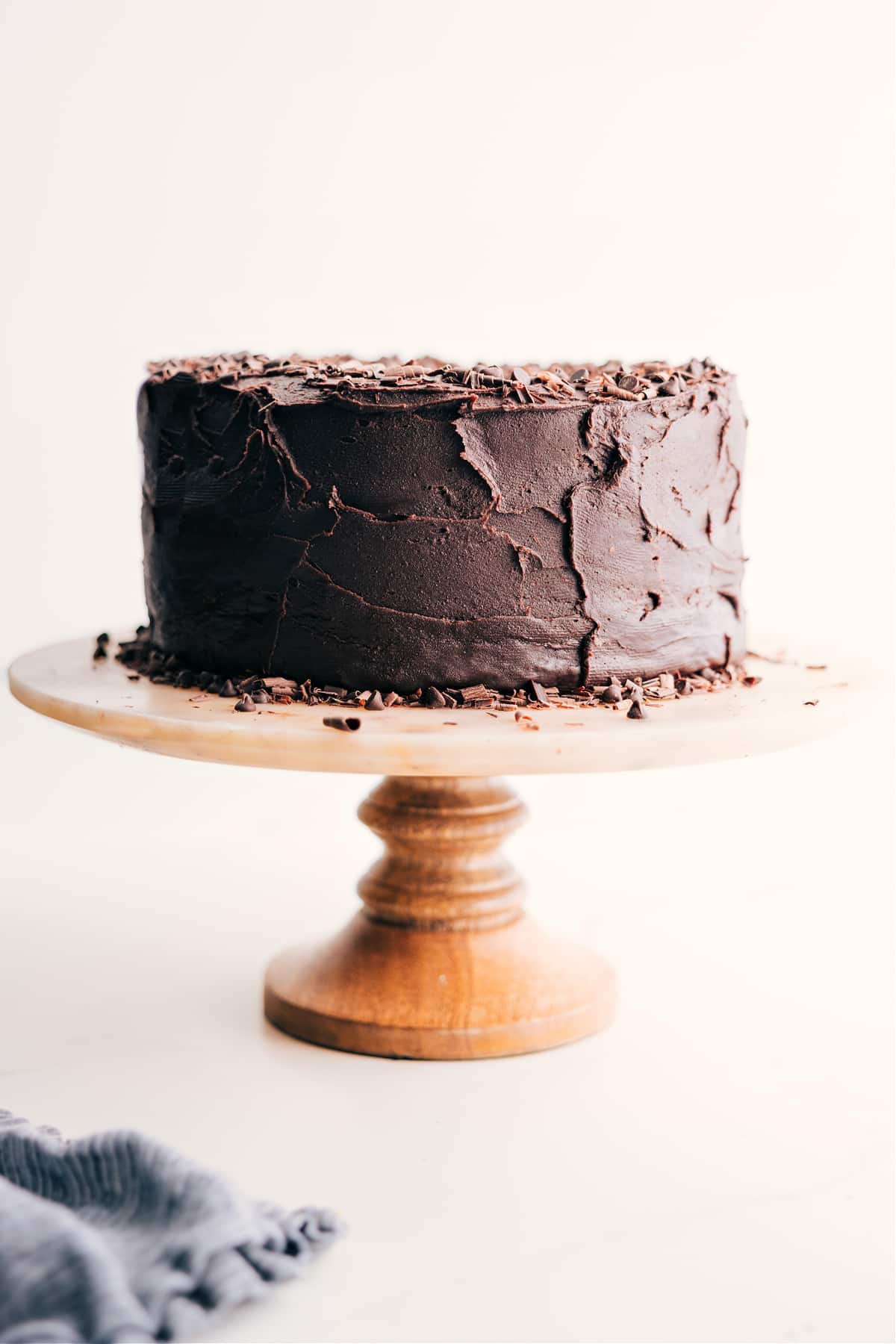 Chocolate Cake Recipe on a cake stand ready to be served and enjoyed.