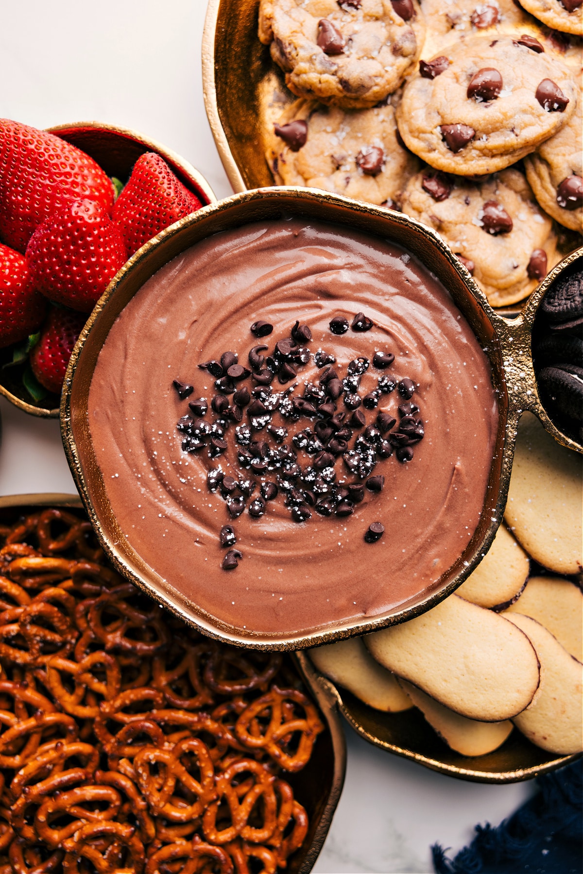 Dip Your Fruit In The Best, Most Decadent Dip The dessert in a bowl with all the dipping options around it.