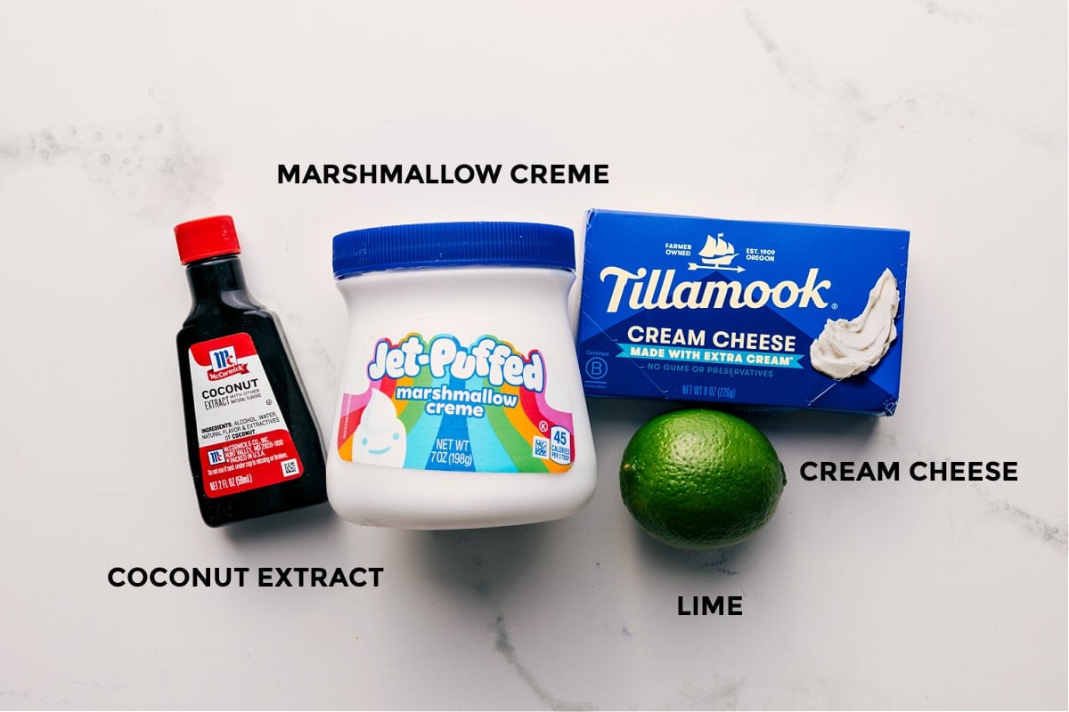 Only Four Ingredients To The Best Cream Cheese Fruit Dip Recipe All the ingredients in this recipe prepped out for easy assembly including the coconut extract, marshmallow creme, cream cheese, and lime.