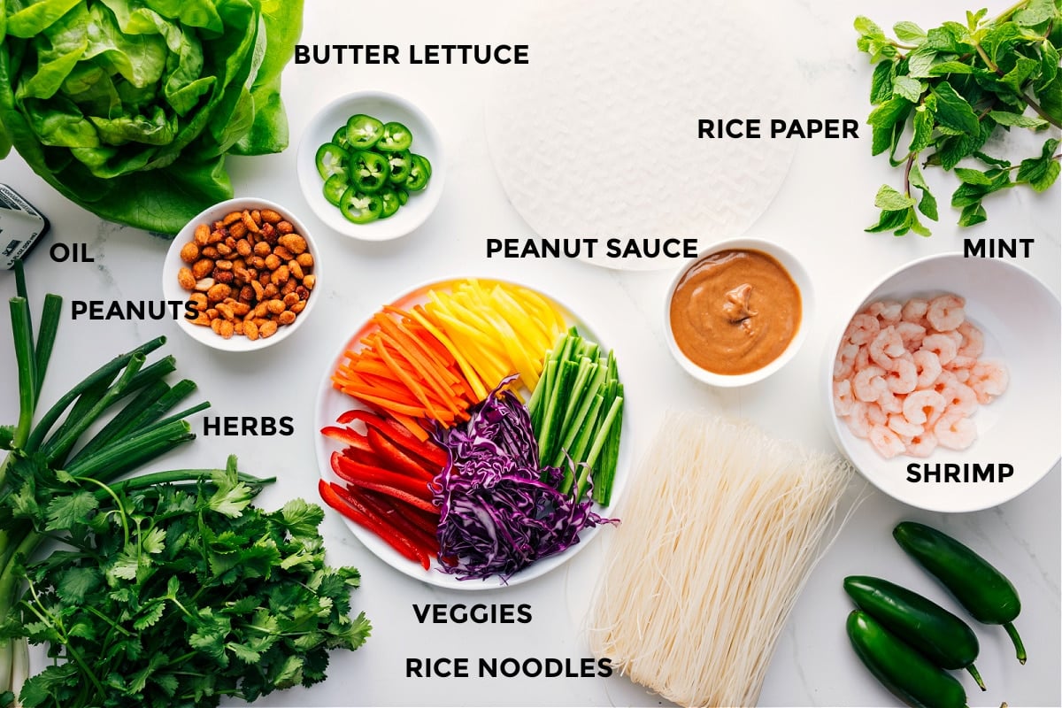 Ingredients In This Spring Rolls Recipe All the ingredients in this recipe prepped out for easy assembly including the lettuce, oil, peanuts, veggies, rice noodles, shrimp, peanut sauce, rice paper, and mint.