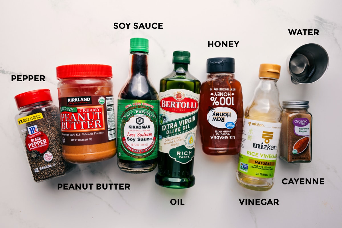 Ingredients In Thai Peanut Dressing All the ingredients in this recipe prepped out for easy assembly including the pepper, peanut butter, soy sauce, oil, honey, vinegar, water, and cayenne.