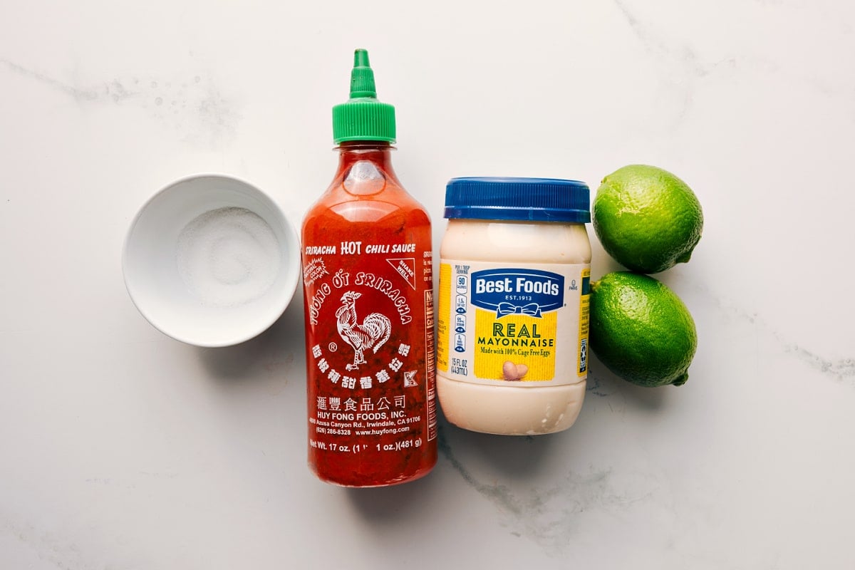 Ingredients In The Delicious Sauce Sugar, mayonnaise, lime, and sriracha prepped for easy assembly of the quick sauce.