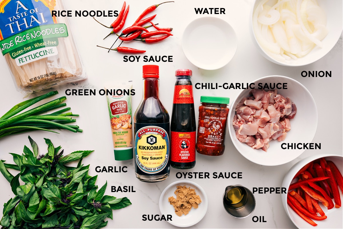 Ingredients In Thai Drunken Noodles Recipe All the ingredients in this recipe prepped out for easy assembly including the rice noodles, green onions, garlic, basil, soy sauce, chili garlic sauce, oyster sauce, sugar, oil, pepper, chicken, onion, and water.