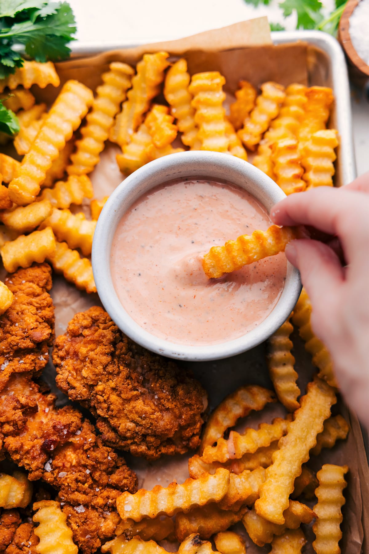 Cane's Sauce Recipe Cane’s sauce recipe in a bowl with a fry dipping into it.