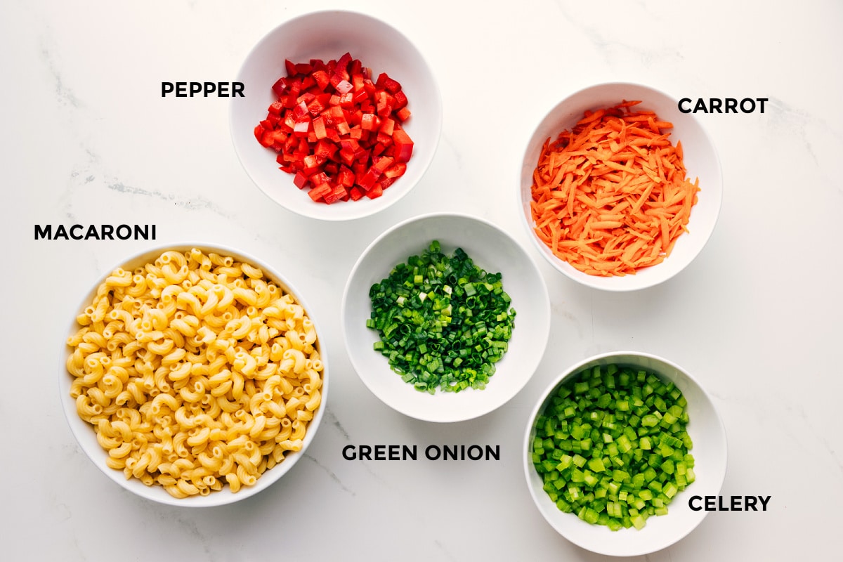 Ingredients In This Macaroni Salad Recipe All the ingredients in this recipe prepped out for easy assembly including the macaroni, pepper, carrot, green onion, and celery.