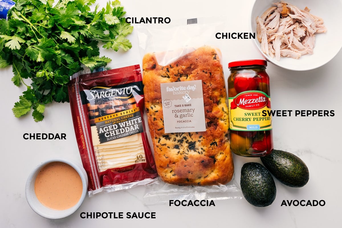 Ingrediens In Panera Chipotle Chicken Avocado Melt All the ingredients in this recipe prepped out for easy assembly including the cilantro, cheddar, chipotle sauce, focaccia, avocado, sweet peppers, and chicken.