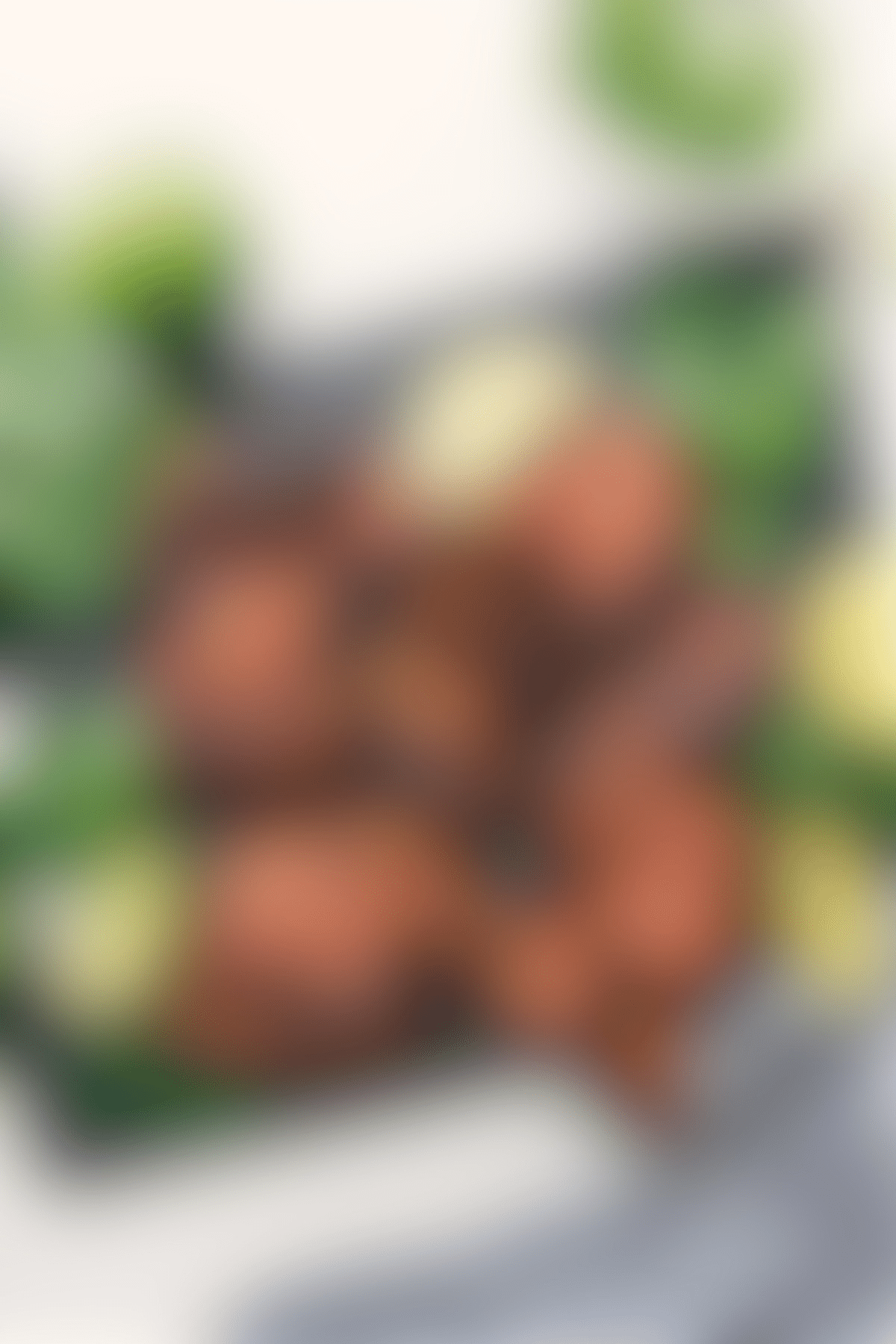 Sweet Green Baked Chicken Thighs Sweet Green baked chicken thighs on the cutting board with fresh cilantro and limes on the side.