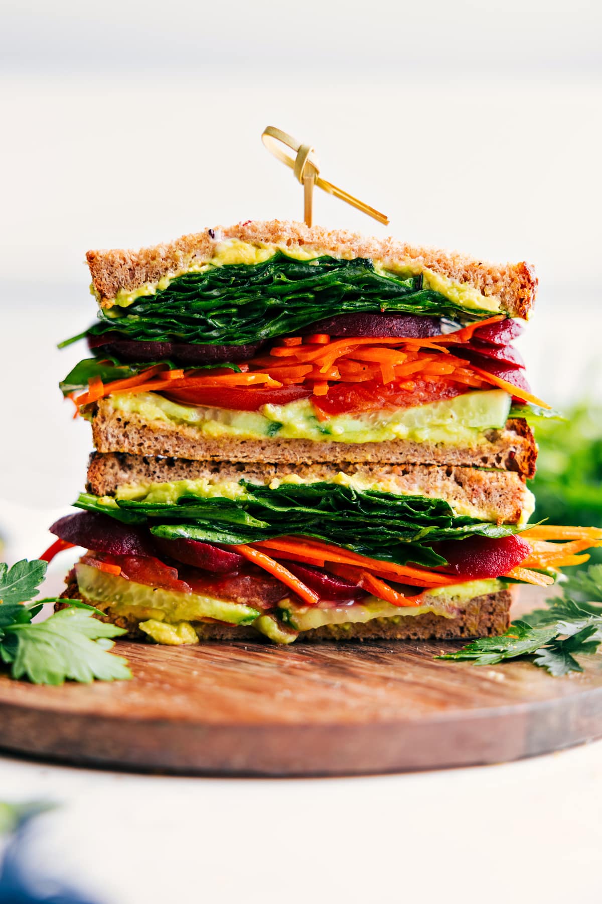 Veggie Sandwich Stacked On Top Of Each Other Veggie Sandwich cut in half and showing all the layers of this delicious sandwich.
