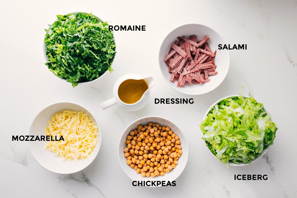 Ingredients In La Scala Chopped Salad All the ingredients in this recipe prepped out for easy assembly including the romaine, mozzarella, salami, iceberg, chickpeas, and dressing.