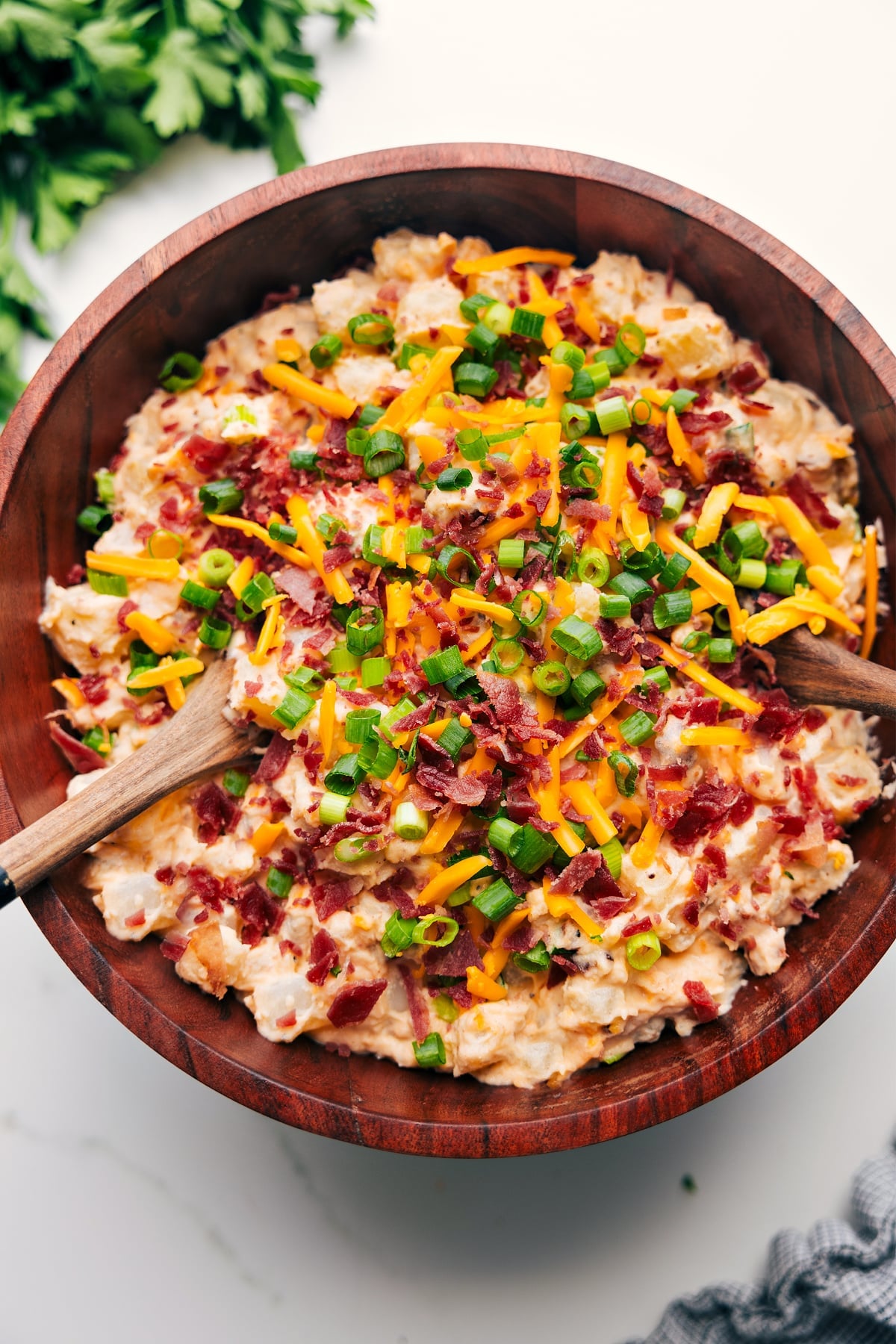 Loaded Potato Salad In A Large Bowl Loaded Potato Salad in a large bowl topped with bacon, cheese, and green onions.