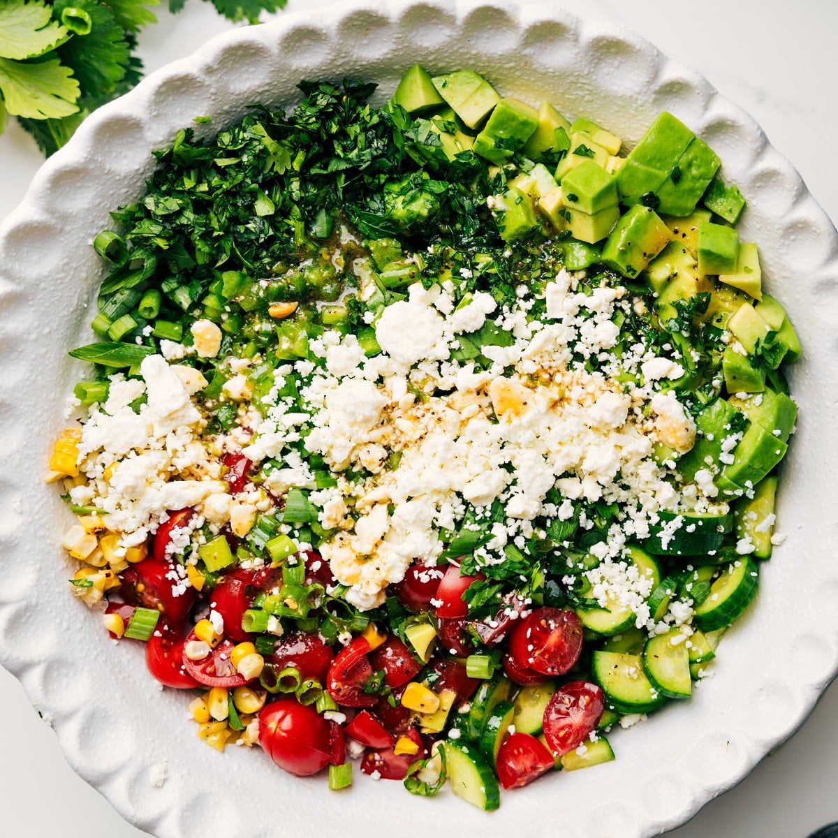How To Make This Corn Salad Recipe All the ingredients in this corn salad recipe added into a bowl to be tossed together.