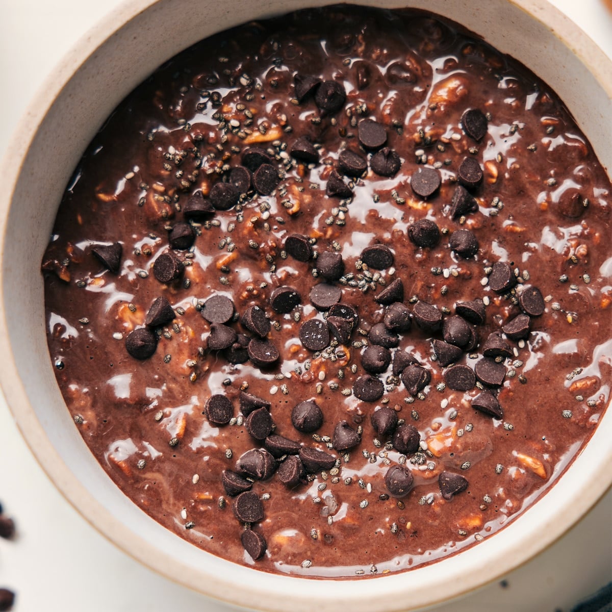 Chocolate overnight oats topped with chocolate chips and chia seeds for a rich, chocolatey breakfast.