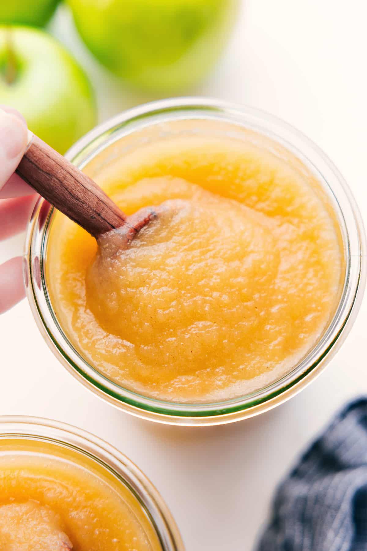 Applesauce Recipe in a jar with a cinnamon stick inside.