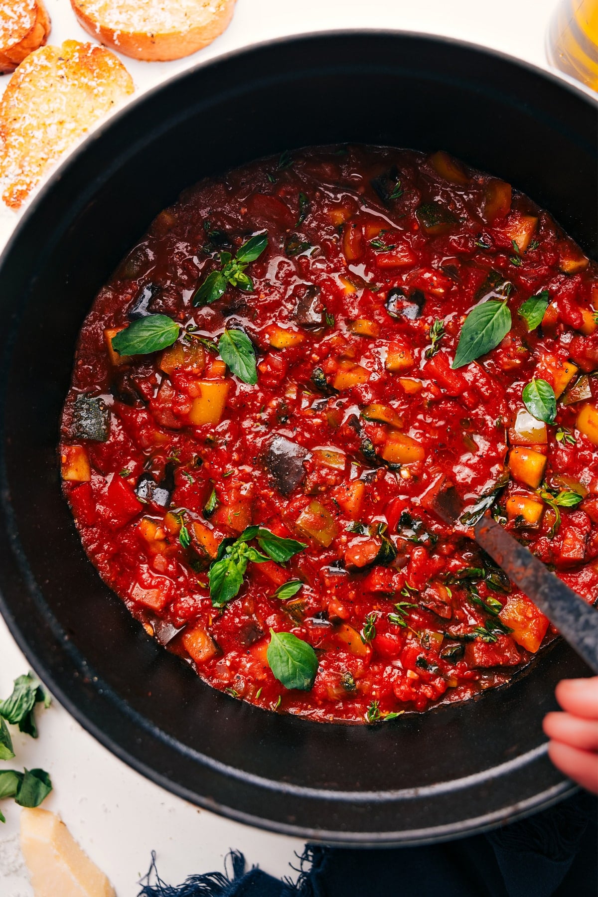 Ratatouille Soup in a pot topped with fresh basil, ready to serve.