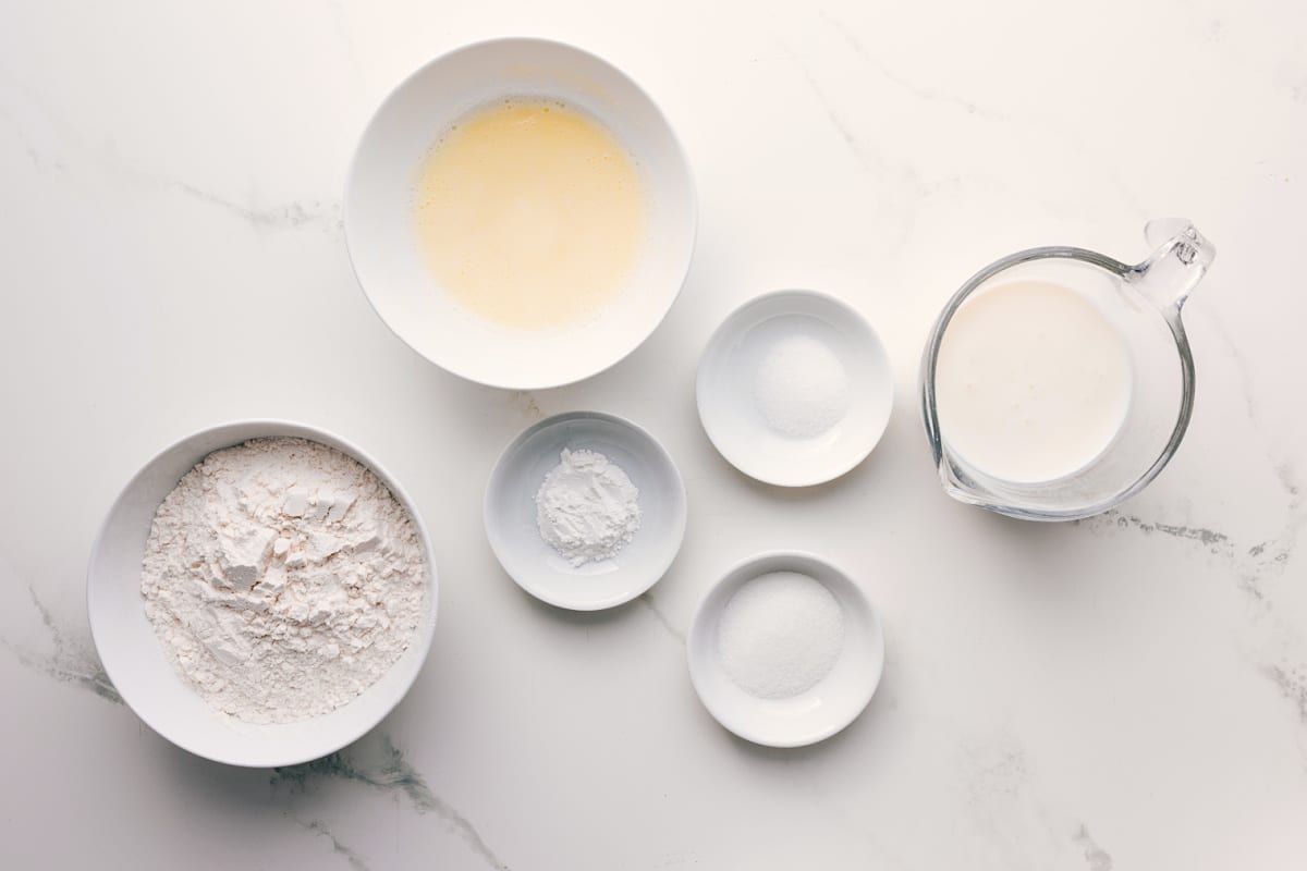 All the ingredients in this recipe prepped out for easy assembly including the flour, butter, baking powder, salt, sugar, and buttermilk.