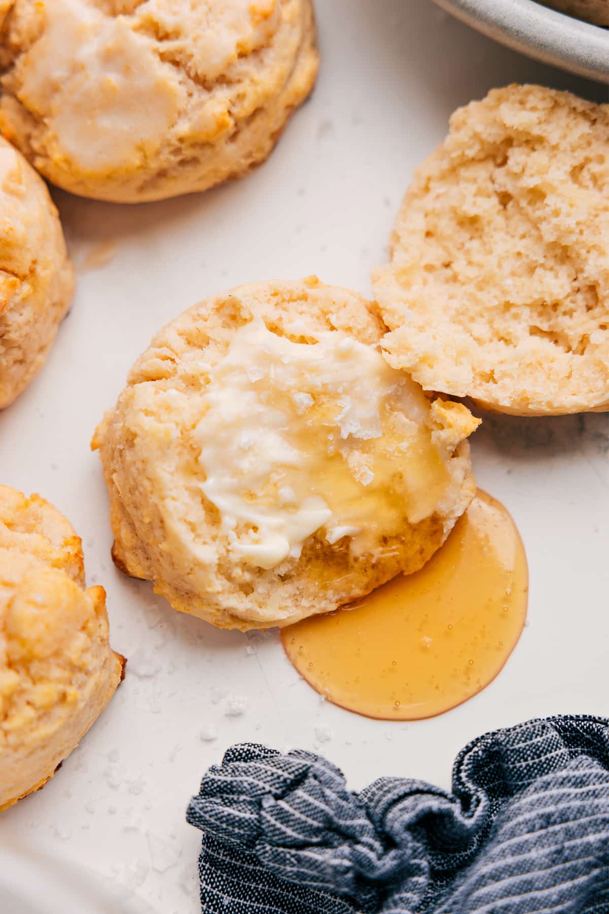 Drop Biscuit Recipe topped with butter and drizzled with honey.