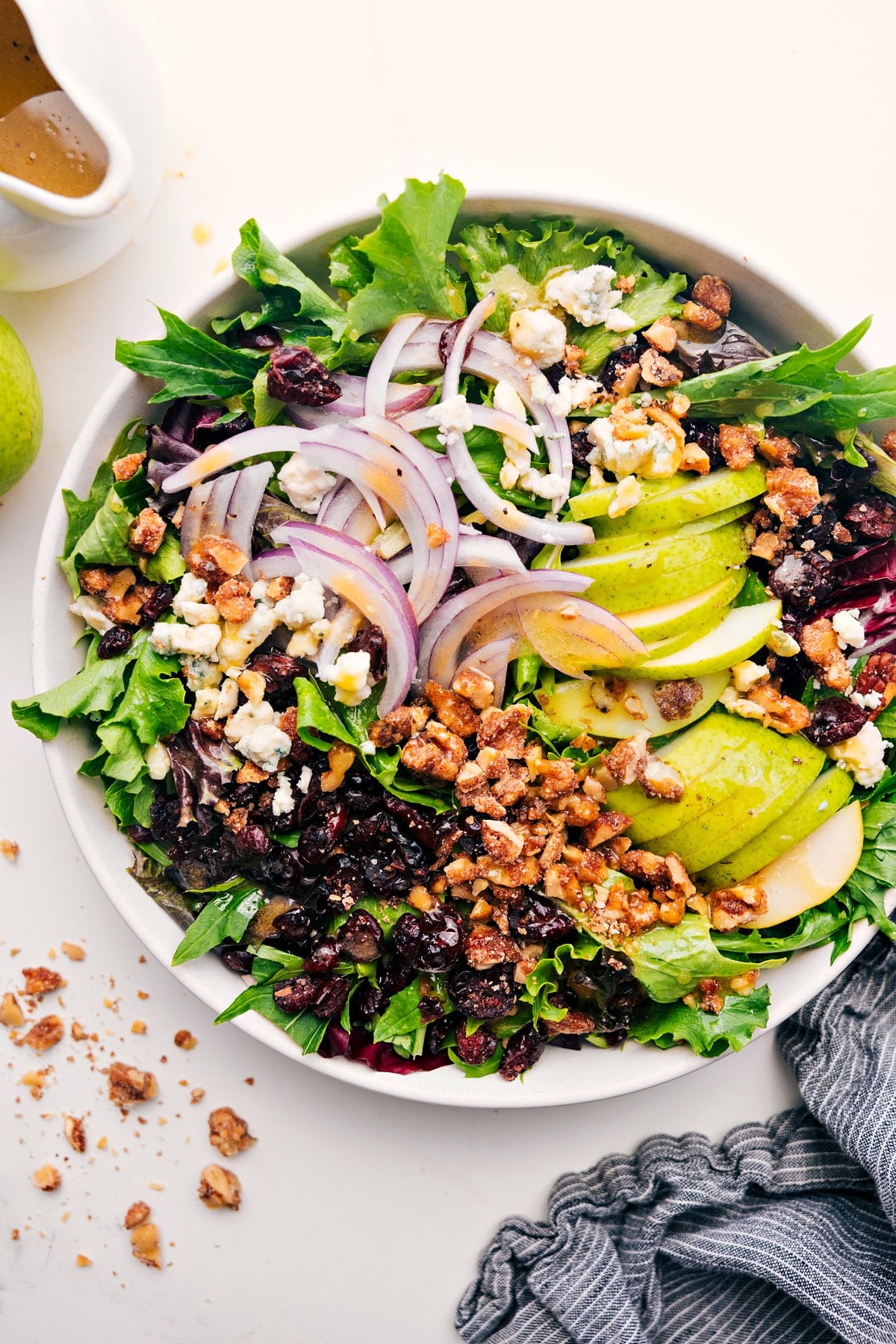 This show-stopping Pear Salad Pear Salad Recipe in a bowl with dressing, ready to toss and serve.