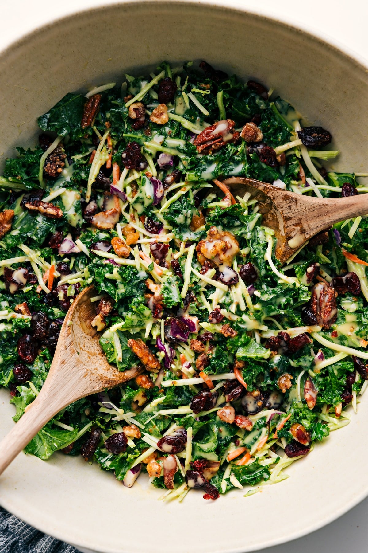 A salad dressed, tossed together, and ready to be enjoyed.